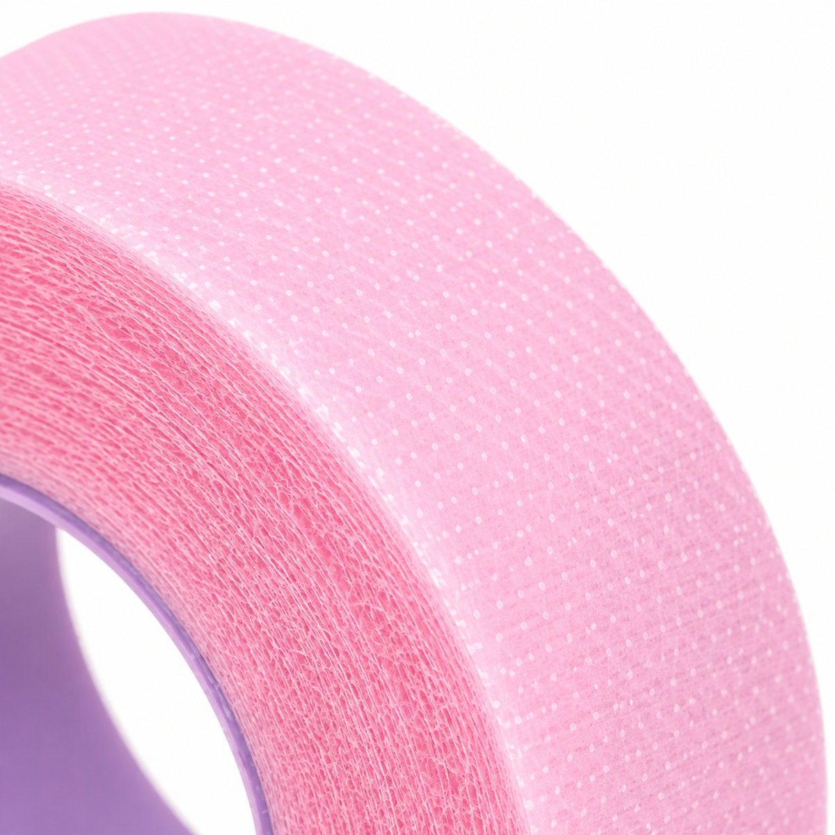 A roll of pink breathable micropore tape designed for lash extension procedures to hold lashes in place and support clean lash application