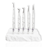 Beginner's Eyelash Tweezers Kit featuring five white marble-pattern lash tweezers with different angled tips displayed on a white stone surface.