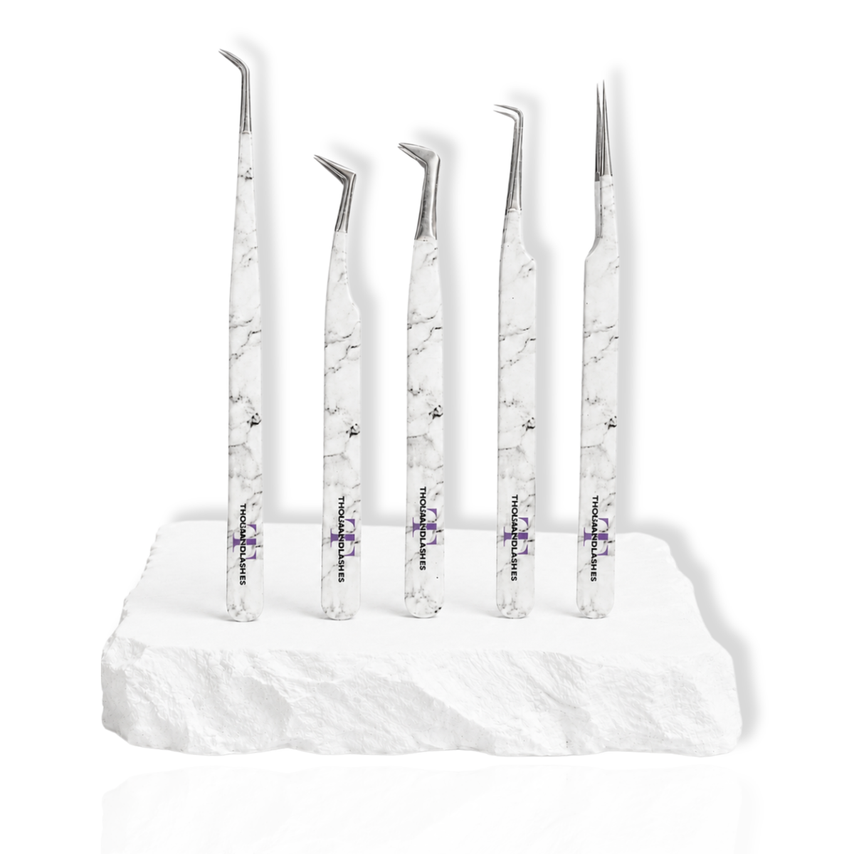 Beginner's Eyelash Tweezers Kit featuring five white marble-pattern lash tweezers with different angled tips displayed on a white stone surface.