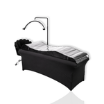 Black lash treatment bed with contoured cushion, protective cover, and adjustable arc lamp