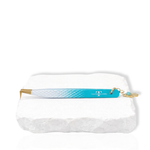 Blue and white thick boot eyelash extension tweezer with gold tip and decorative charm displayed on a white stone surface.