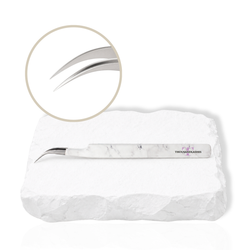 Dolphin curved lash tweezer with angled tip displayed on a white stone background