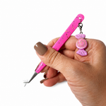 Hand holding a Thousandlashes Candy Charm 45-degree isolation tweezer with lash extensions at the tip.