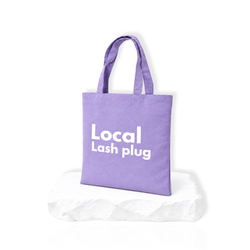Local Lash Plug purple tote bag for lash artists displayed on a white platform, perfect for carrying lash supplies and beauty essentials