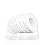 Multiple rolls of white eyelash extension tape displayed on a white platform for lash artists