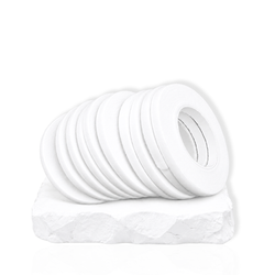 Multiple rolls of white eyelash extension tape displayed on a white platform for lash artists