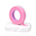 Pink breathable micropore tape roll used by lash artists to hold down lower lashes or lift the eyelid during lash extension applications.