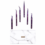 Purple lash tweezers set displayed above a marble storage case for eyelash extension tools and precision lash application.