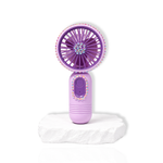 Purple portable lash fan with rhinestone detailing displayed on a white stone surface.