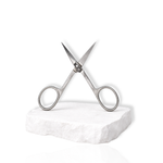 Stainless steel precision lash scissors with open blades displayed on a white stone surface against a white background.