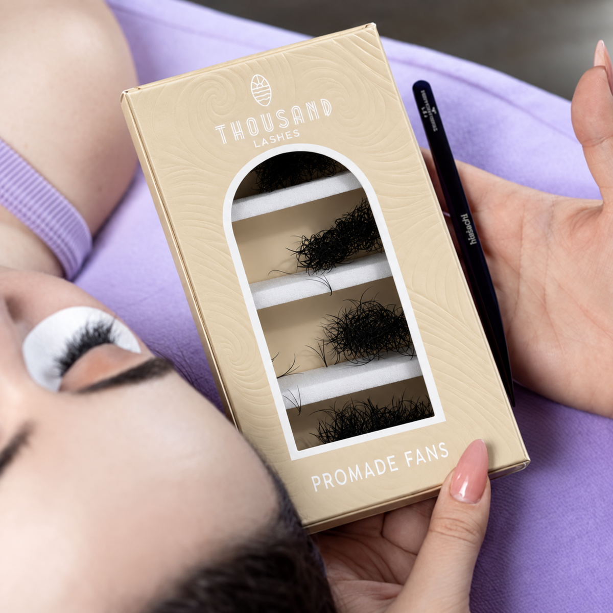 ThousandLashes Promade Fans lash box held beside a client during lash application