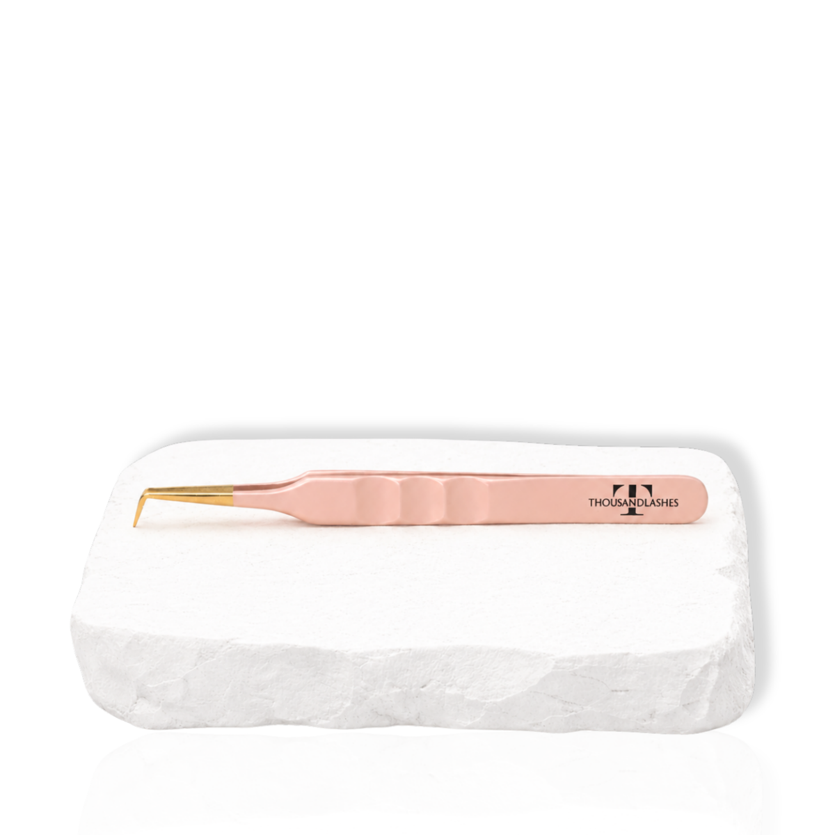 Thousandlashes nude 90-degree tweezer on a white stone surface.