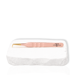 Thousandlashes nude 90-degree tweezer on a white stone surface.