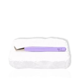 Thousandlashes purple Summer Spring Collection angled lash tweezer shown from the reverse side on a white stone surface.