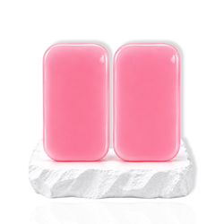 Two pink silicone eyelash holder pads displayed on a white stone surface.