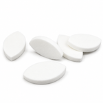 White eyelid shaped practice sponges arranged on a white background for eyelash extension training and lash mapping practice.