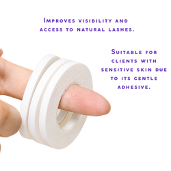 White lash tape roll held by hand showing narrow adhesive tape for eyelash extension under-eye support