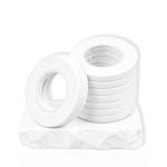 White narrow lash tape rolls stacked on a white stone surface for eyelash extension application