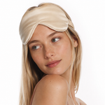 Woman wearing a silk lash mask with padded eye covers for comfortable eyelash extension aftercare and rest.