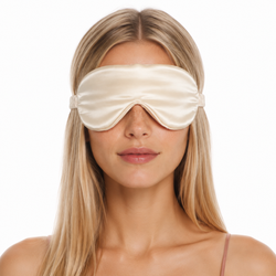 Woman wearing a silk lash sleep mask designed to protect eyelash extensions while sleeping.