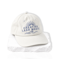 thousandlashes Lash Artist Cap with “Creating Lash Magic” embroidery, shown at a slight angle.