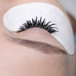 Before and after of a wispy lash extension set showing added length and volum
